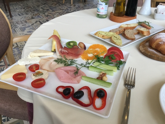       Plate with assorted food items including vegetables and meats.
  