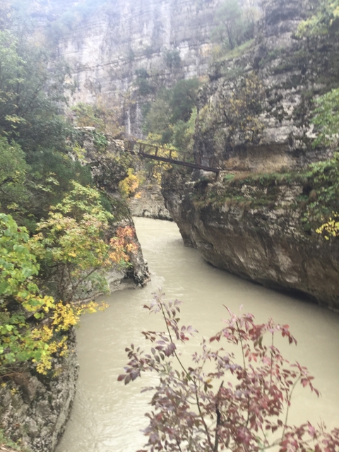       Canyon with a small river running through it.
  