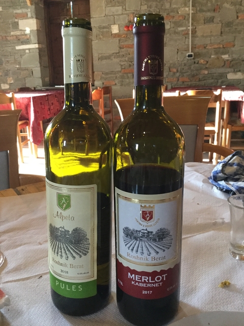       Two bottles of wine on a table.
  