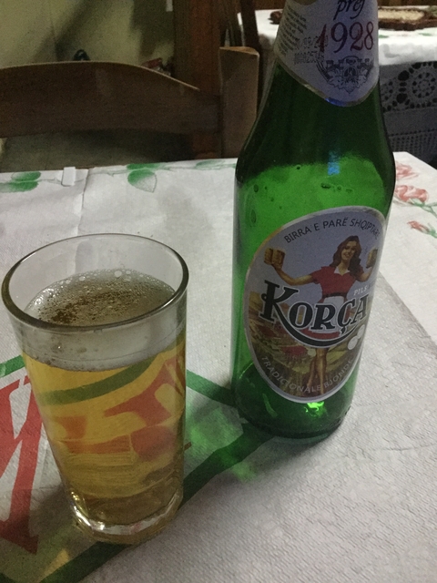 Bottle and glass of beer on a table.