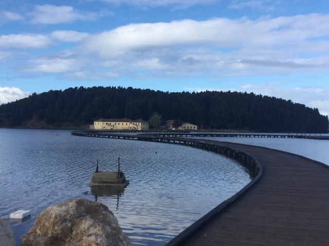 Boardwalk over water leading to a building in the distance.