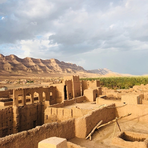       Ancient ruins in a desert landscape.
  