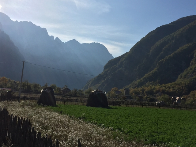 Valley with agricultural fields and distant mountains.