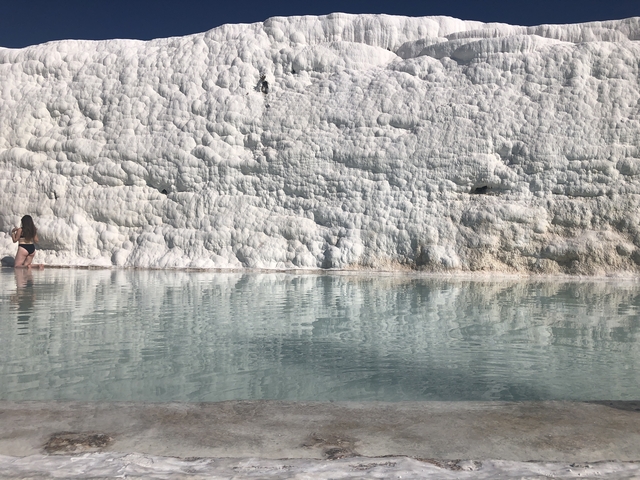       Person dipping her feet in the thermal waters of Pamukkale.
  