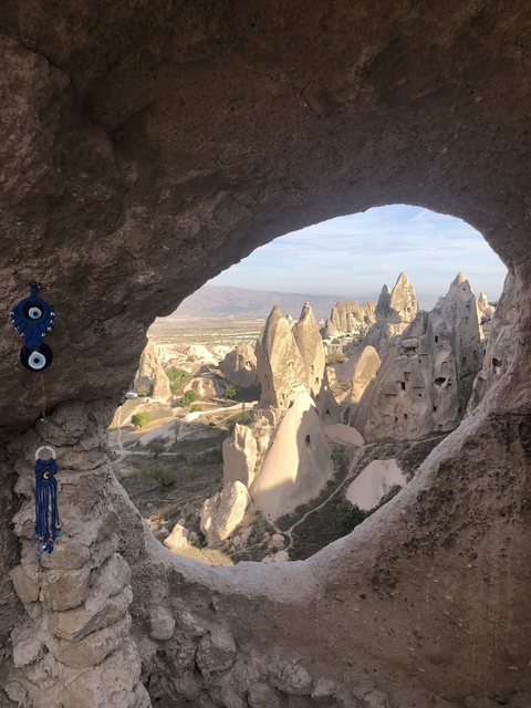      Sunlit rocky formations in Cappadocia from a cave perspective.
  