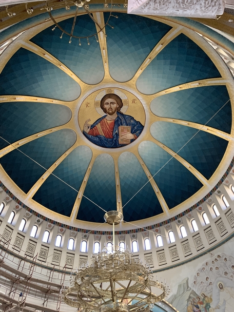 Ceiling fresco of a religious figure in a dome.