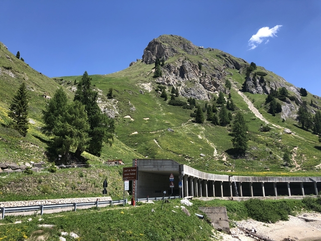 Mountain landscape with road tunnel and lush greenery