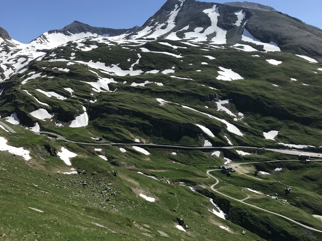 Snowy mountain roads with patches of green