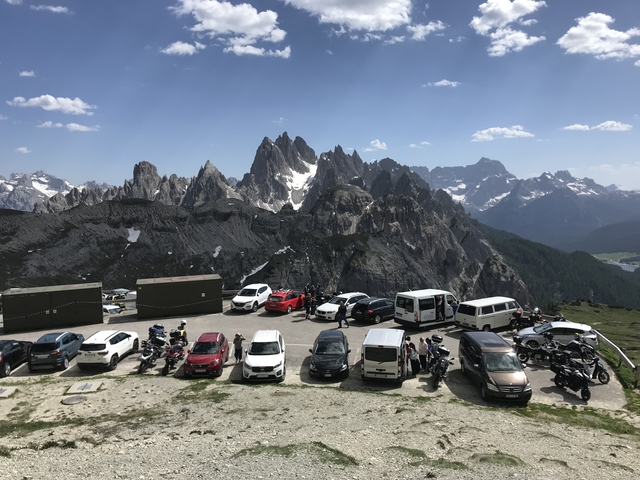 Mountain peaks with cars parked at a viewpoint