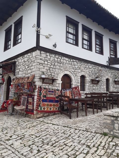 Traditional stone building with colorful rugs and handicrafts