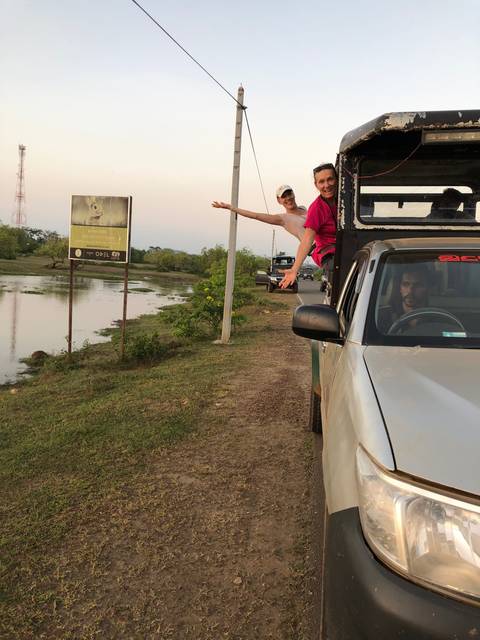       People leaning out of a vehicle enjoying the view.
  