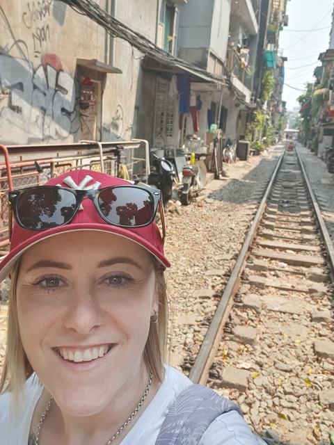       Close-up of a person by train tracks.
  