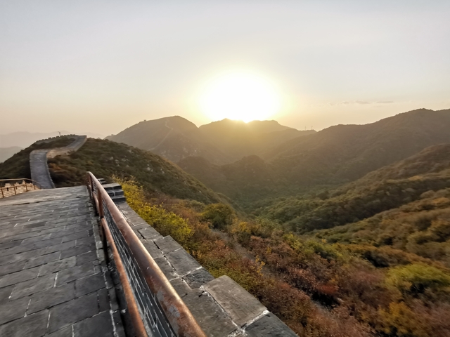 Sunset view of a famous stone wall across scenic hills.