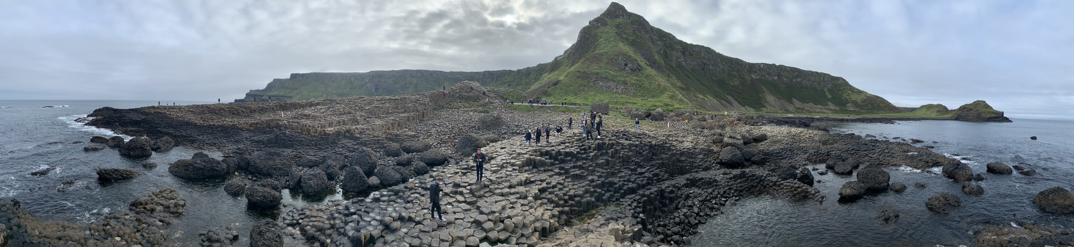 Visitors exploring Giant's Causeway with distinctive rock columns.