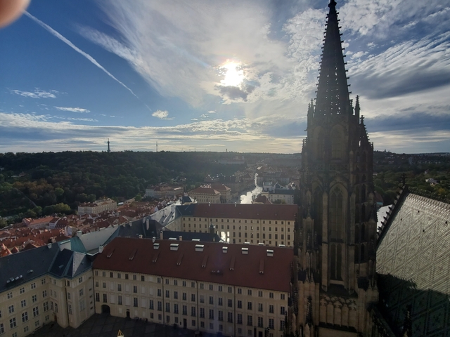 View over Prague with a cathedral spire and river.