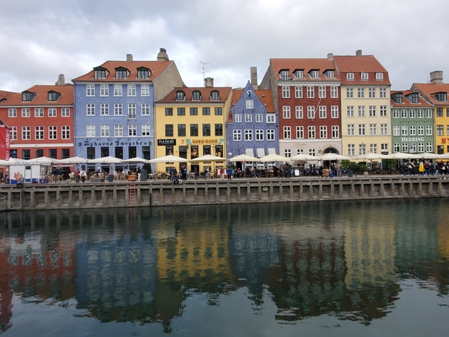       Colorful buildings reflecting in the canal at Nyhavn, Copenhagen.
  