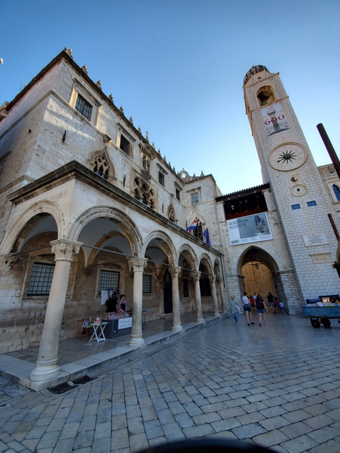 Rector's Palace in Dubrovnik with people walking around.