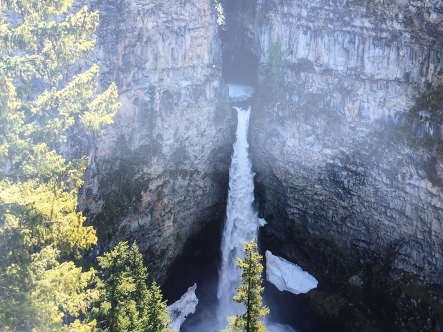 Tall waterfall cascading down a rocky cliff.