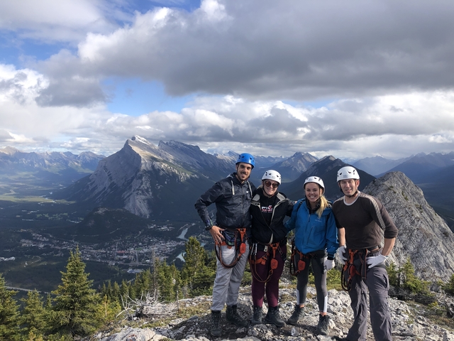 Group of climbers posing on a mountain with gear.