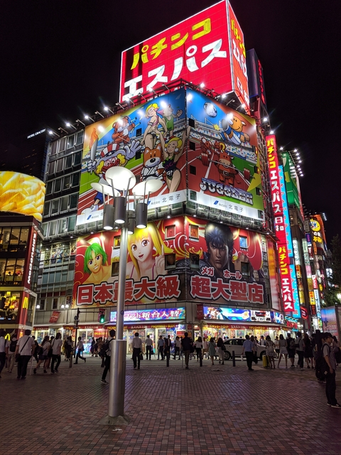       Colorful advertisements and lights on a building at night
  