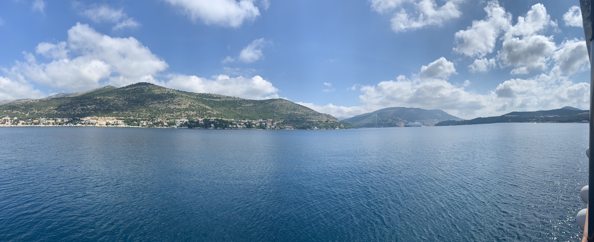 Panoramic view of an island coastline with a blue sky.