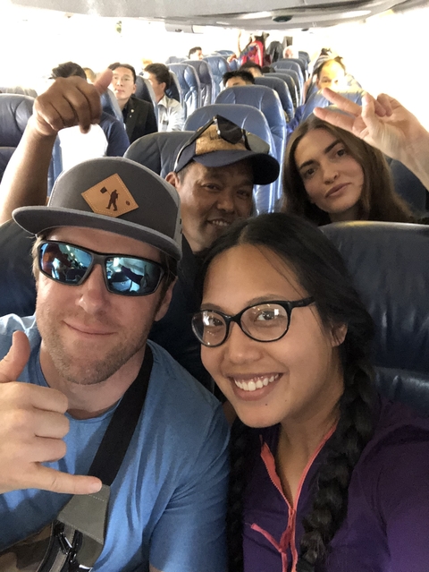Group of people taking a selfie in a vehicle.