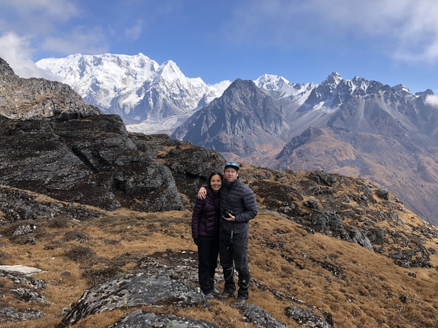 Couple standing in front of mountains.