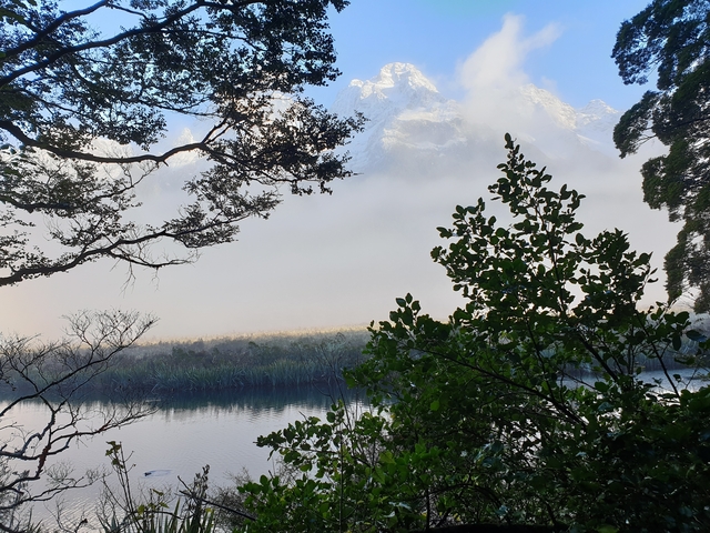 Lake with misty mountains in the background.