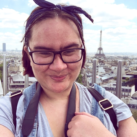 A selfie with the Eiffel Tower visible in the background.