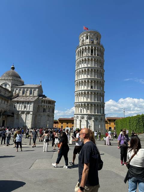       Leaning Tower of Pisa with tourists around.
  