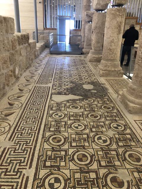 Ancient mosaic floors with intricate designs.