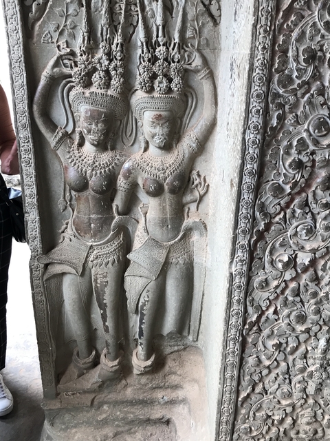       Relief sculpture with intricate carvings on a wall.
  