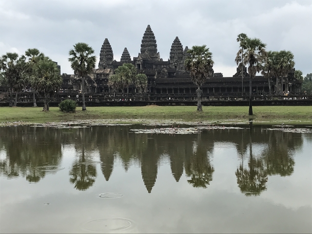       Angkor Wat temple with reflection in a pond.
  