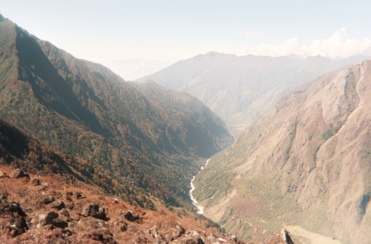 Expansive view of a valley and river in a mountainous area