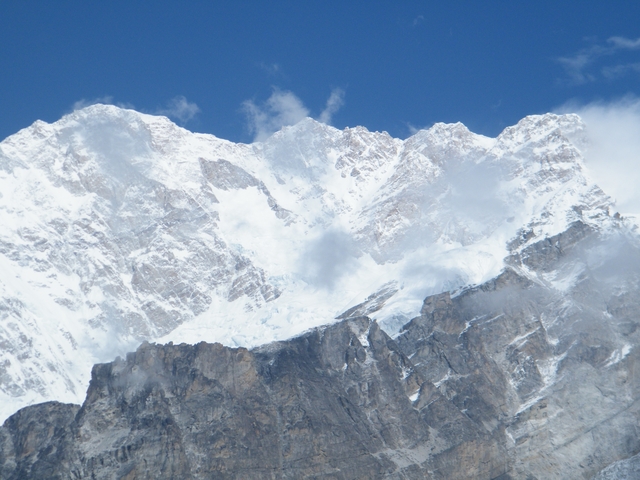 Snow-covered mountain peaks with bright blue sky