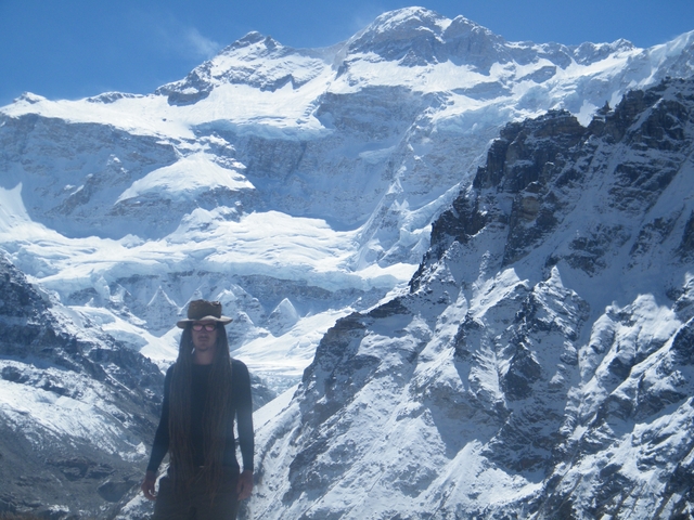 Hiker posing in front of snow-covered mountains