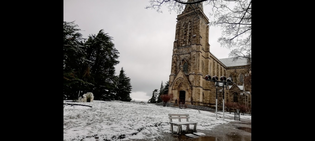       Snowy church exterior in a winter setting.
  