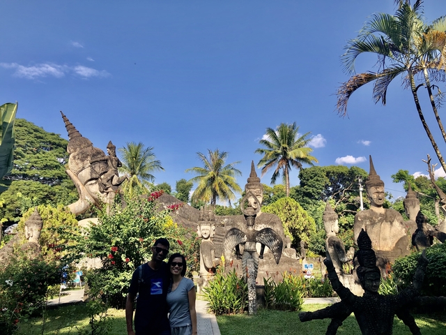       Park with large sculptures and tropical plants.
  