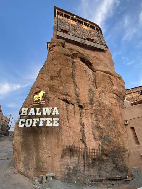 Stone building with a coffee shop sign.