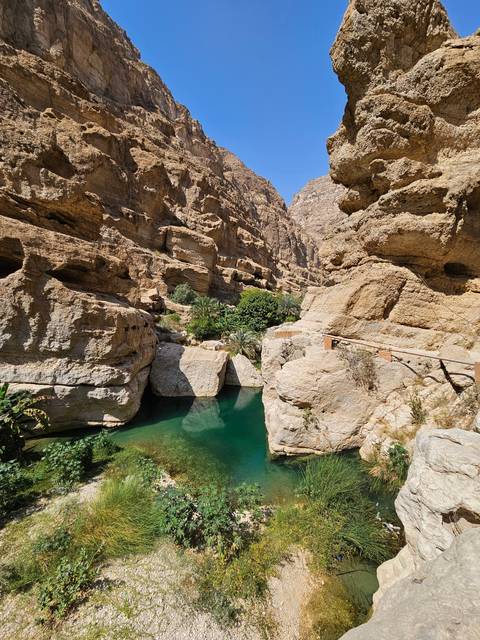 Bright landscape with rocks and green water.