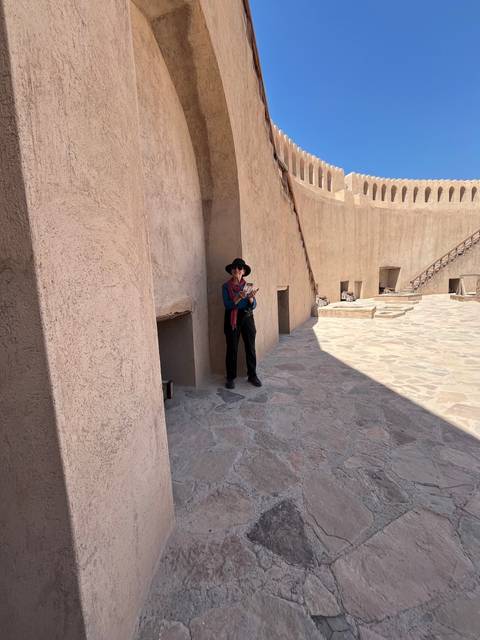 Tourists walking through the fort's stone pathways.
