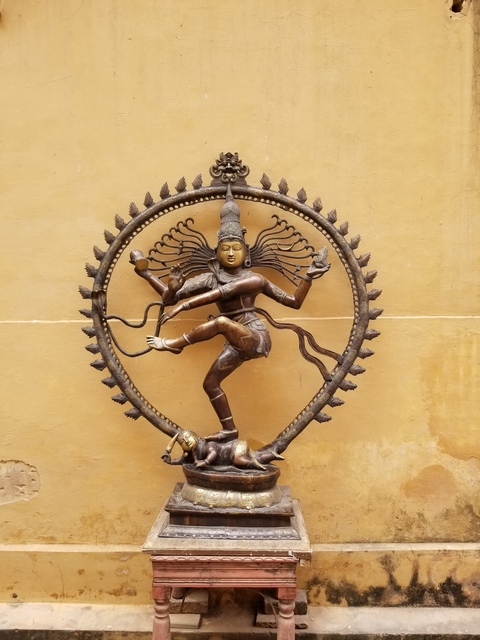 Bronze statue of a dancing figure.