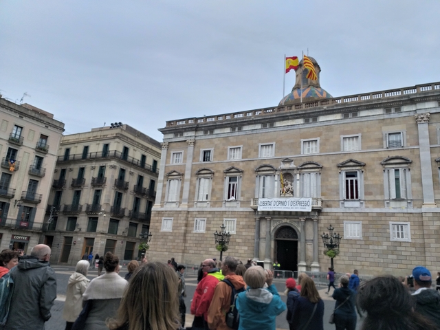 Plaça Sant Jaume in Barcelona with flags and crowd.