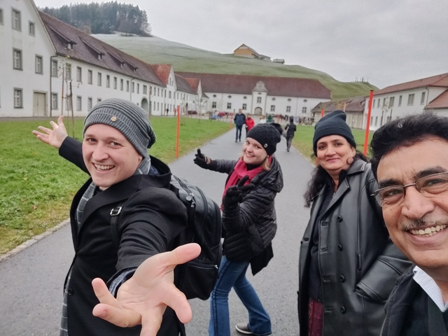 Group of people posing happily on a pathway.