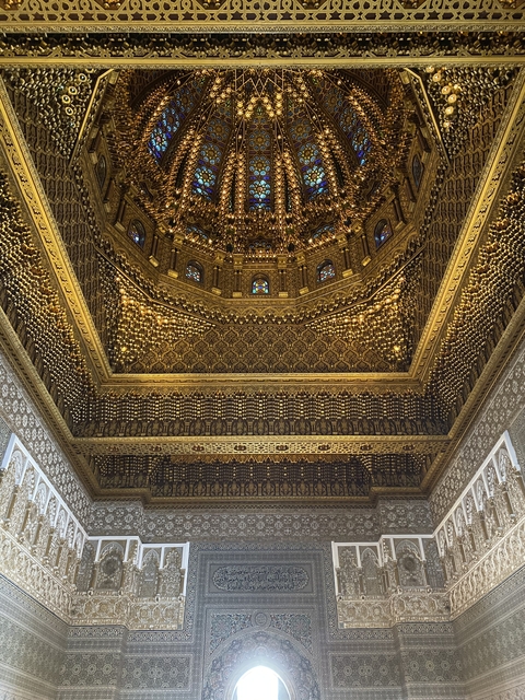       Elaborate golden ceiling with intricate designs.
  