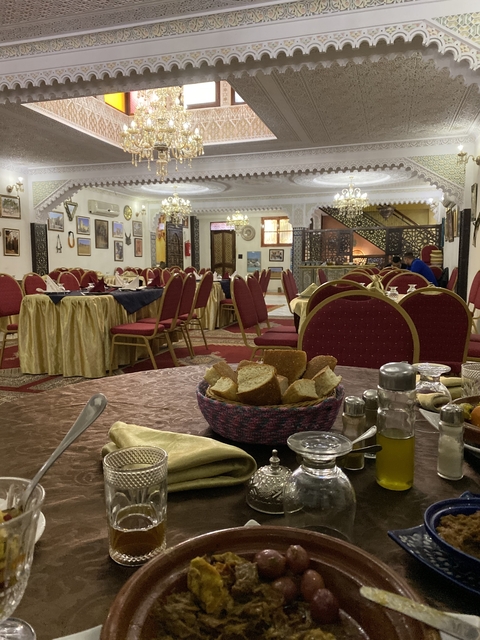       Interior of a dining area with chairs and tables set up.
  