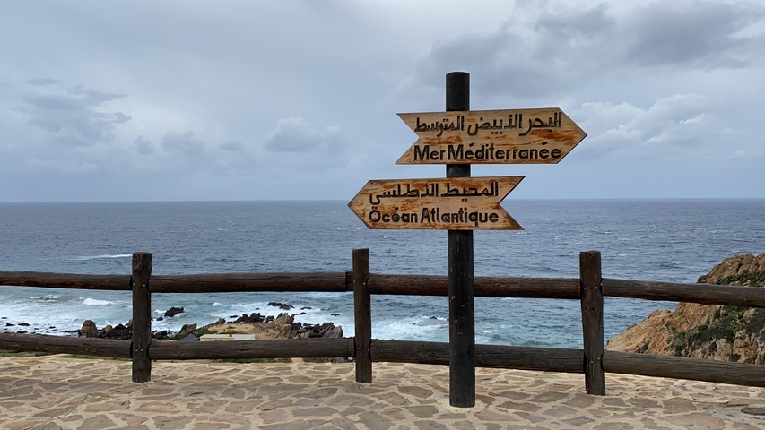       Directional sign on a viewpoint overlooking the sea.
  