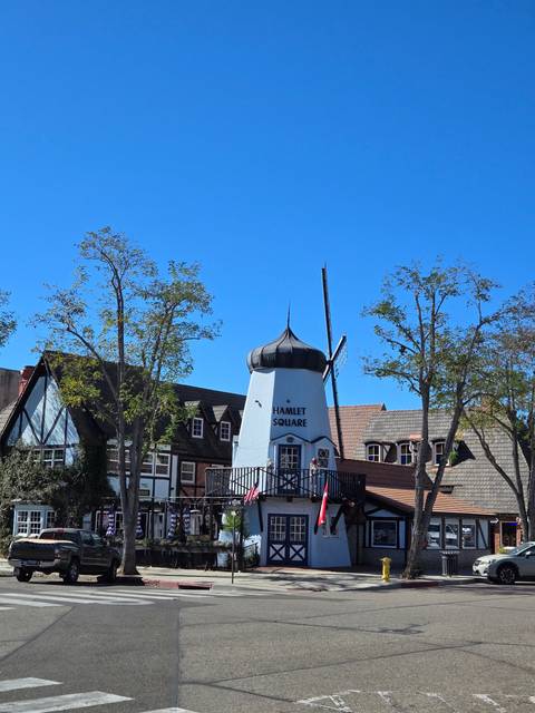 Windmill building in a quaint town square.