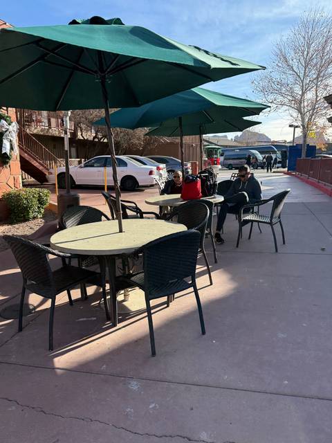 Outdoor cafe with people sitting at tables.