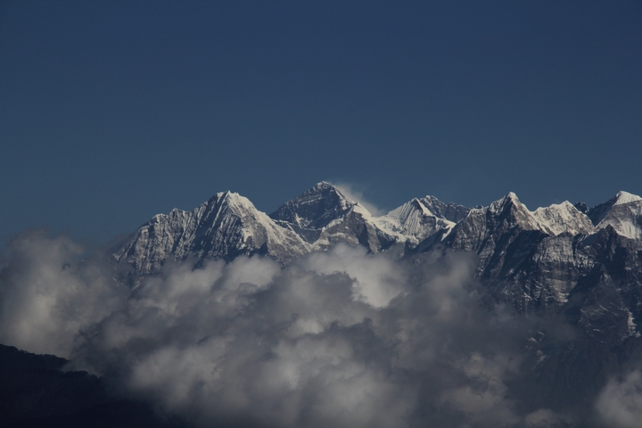 Mountain range with clouds at the base.